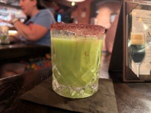 Green cocktail with chili rim at La Cava del Tequila, Epcot