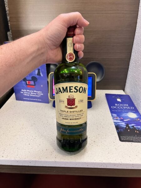 Hand holding bottle of Jameson Triple Distilled Irish Whiskey