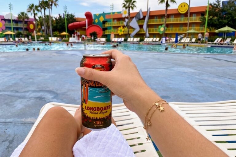 Kona Longboard Island Lager can held poolside at Disney's Pop Century Resort