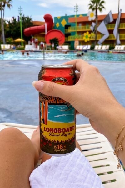 Hand holding a Longboard Island Lager can at a Disney World pool