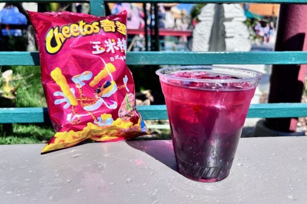 Honey Hibiscus Hard Iced Tea next to a bag of Cheetos on a ledge in the China pavilion at EPCOT