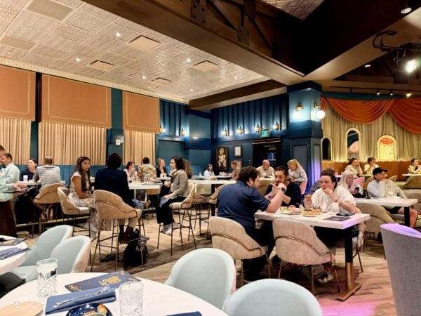 The brightly lit Hurly-Burly lounge with guests at marble tables