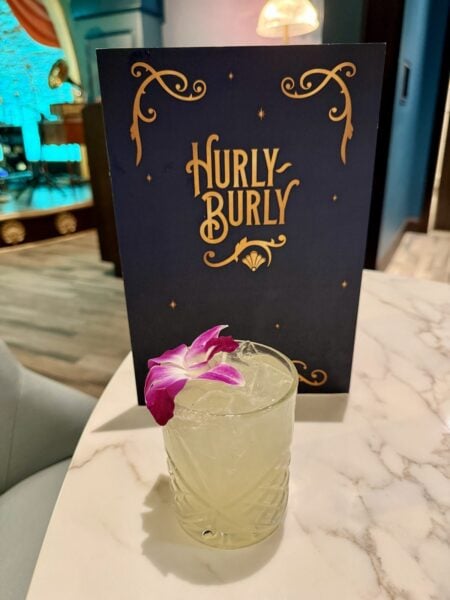 La Taquilla Picante cocktail with an orchid garnish at Hurly-Burly