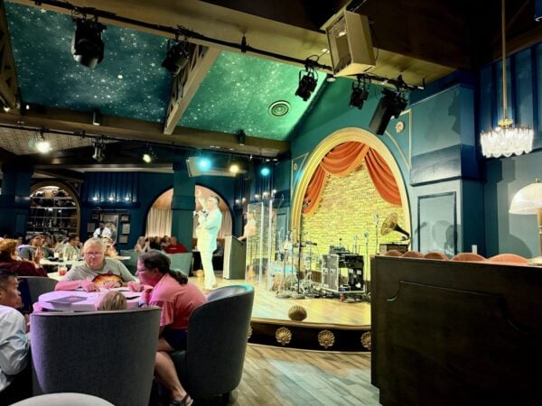 Trivia host on stage during family-friendly games at Hurly-Burly