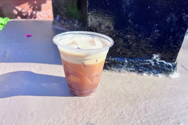 Tutto Gusto espresso martini over ice in a clear plastic to-go cup at EPCOT's Italy pavilion